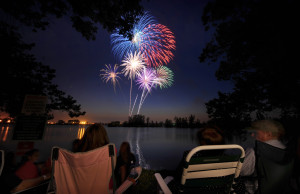 OFFUTT AIR FORCE BASE, Neb. - Bursts of red, white and blue fill the night sky July 2 at Offutts base lake during the annual fireworks display.  Several family activities took place at the celebration including appearances by a professional magician and a small play given by Prairied Treasure Melodrama. U.S. Air Force photo by Josh Plueger